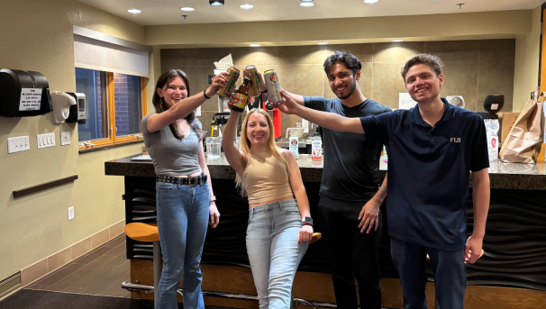 Four NAU Brew Club members toasting.
