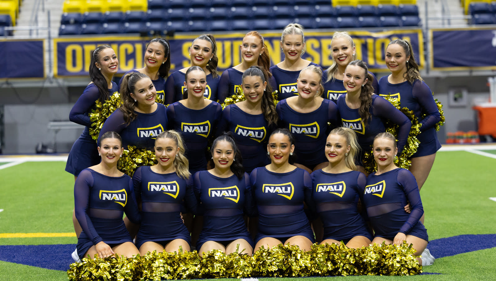 Dance Team posing in blue uniforms on the field
