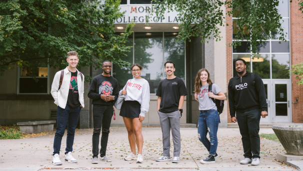 Six students standing in front of the Moritz College of Law building