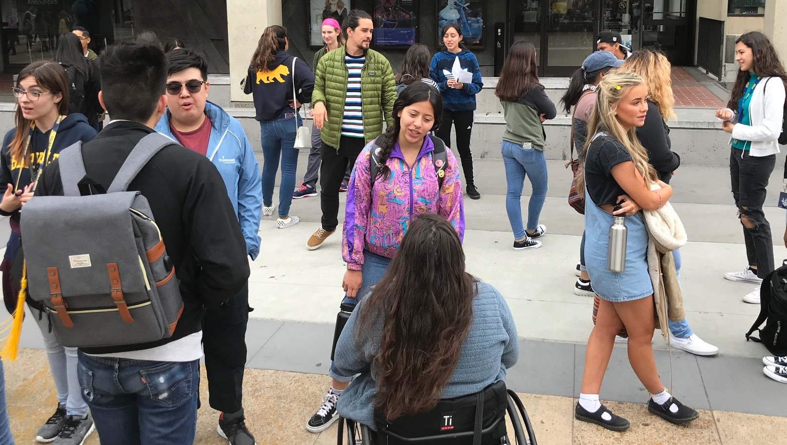 A diverse group of Berkeley Connect students talk with each other on Lower Sproul Plaza