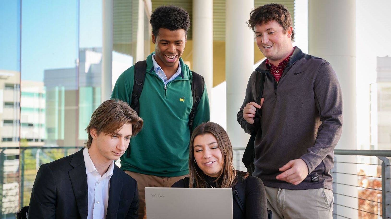 students outside on laptop