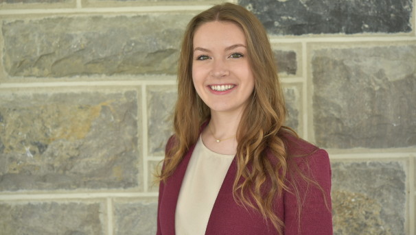 Sydney smiles in a professional headshot