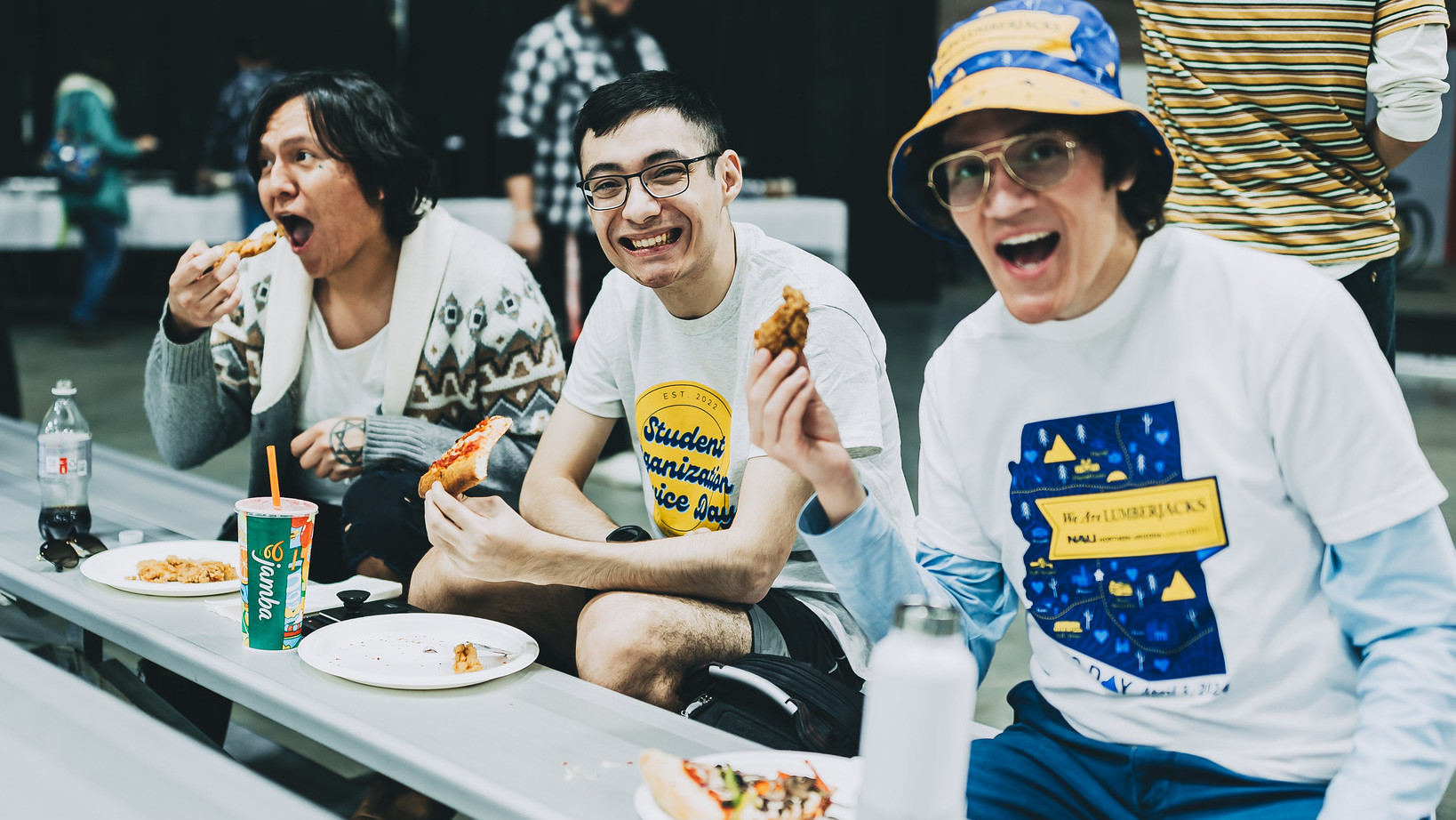 Students attending the student giving event and eating pizza