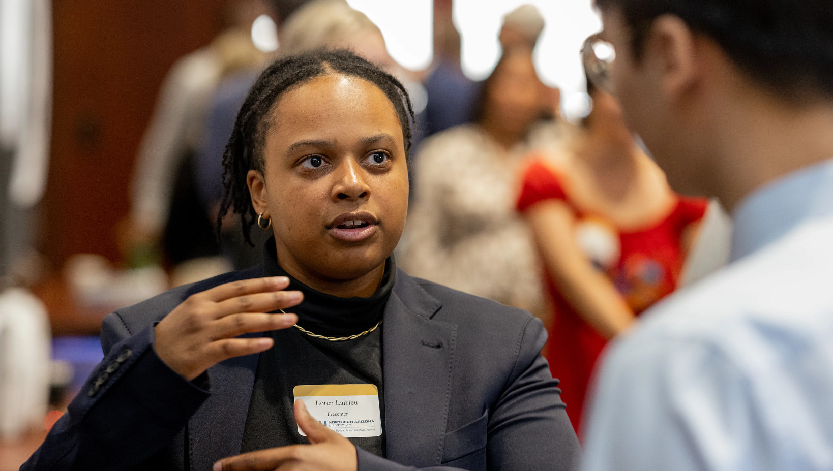 Student presenter discussing research with an attendee