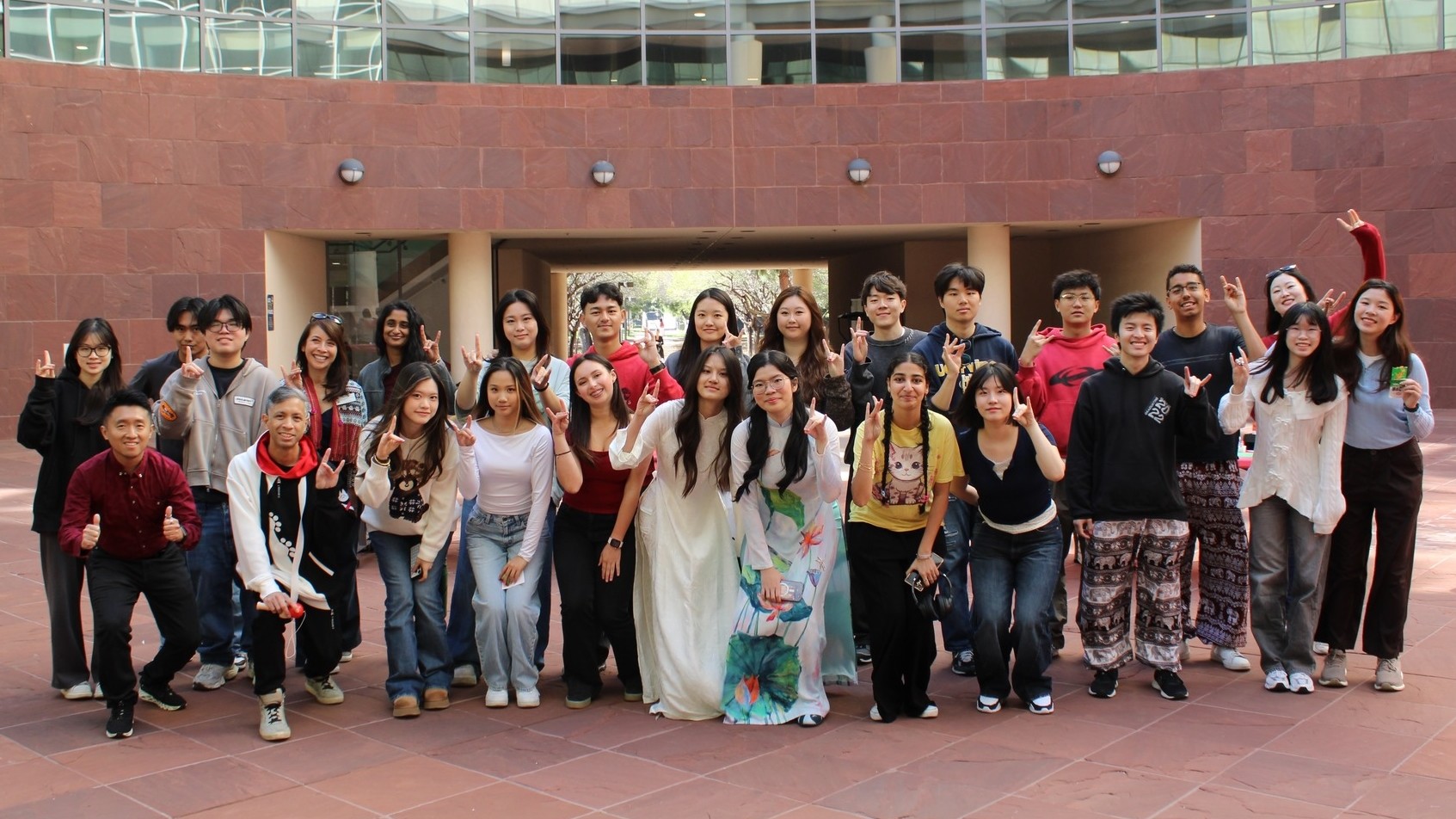 Members of the UCI International Center posing for a photo at a promotional booth on campus
