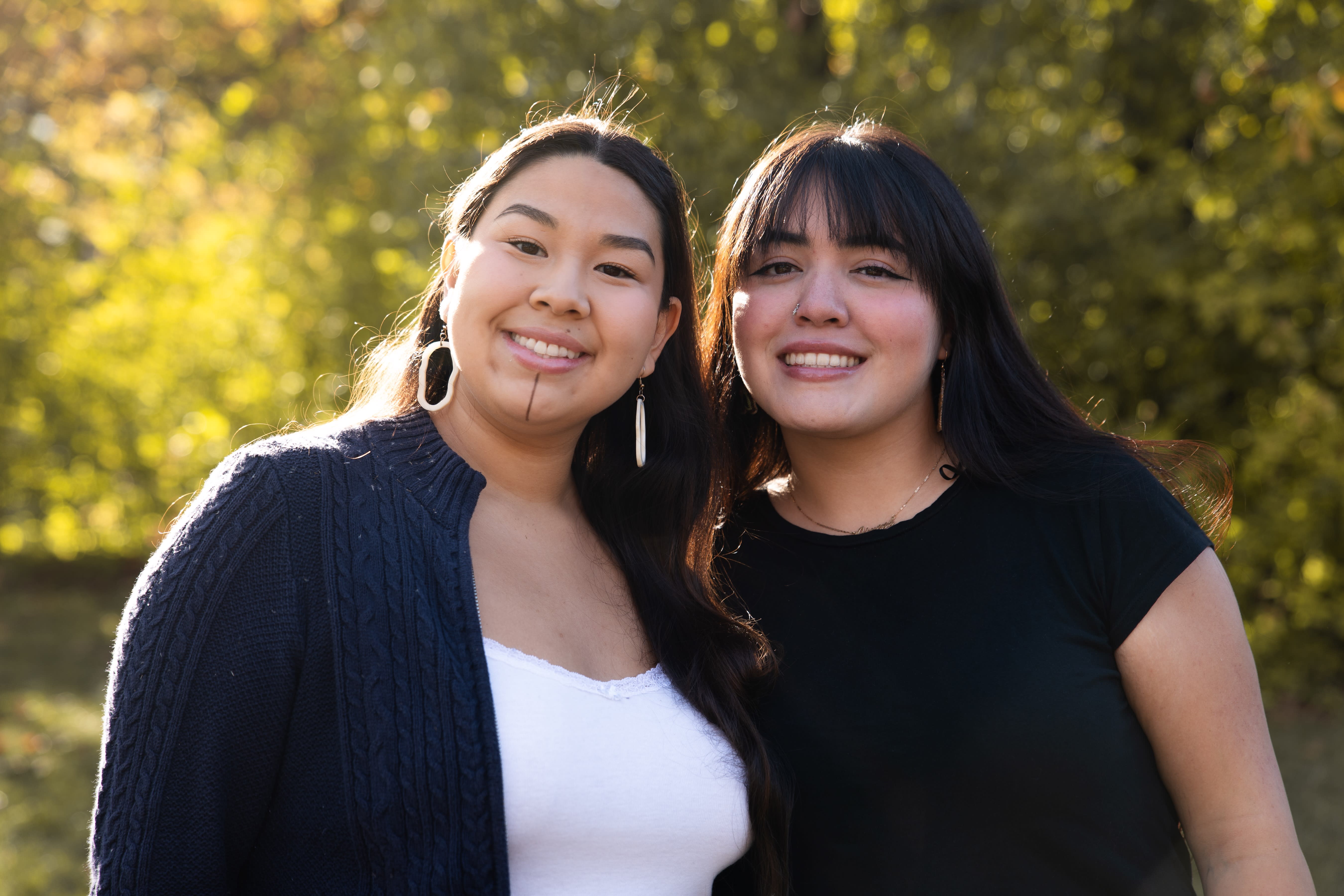 Two girls smiling at the camera.