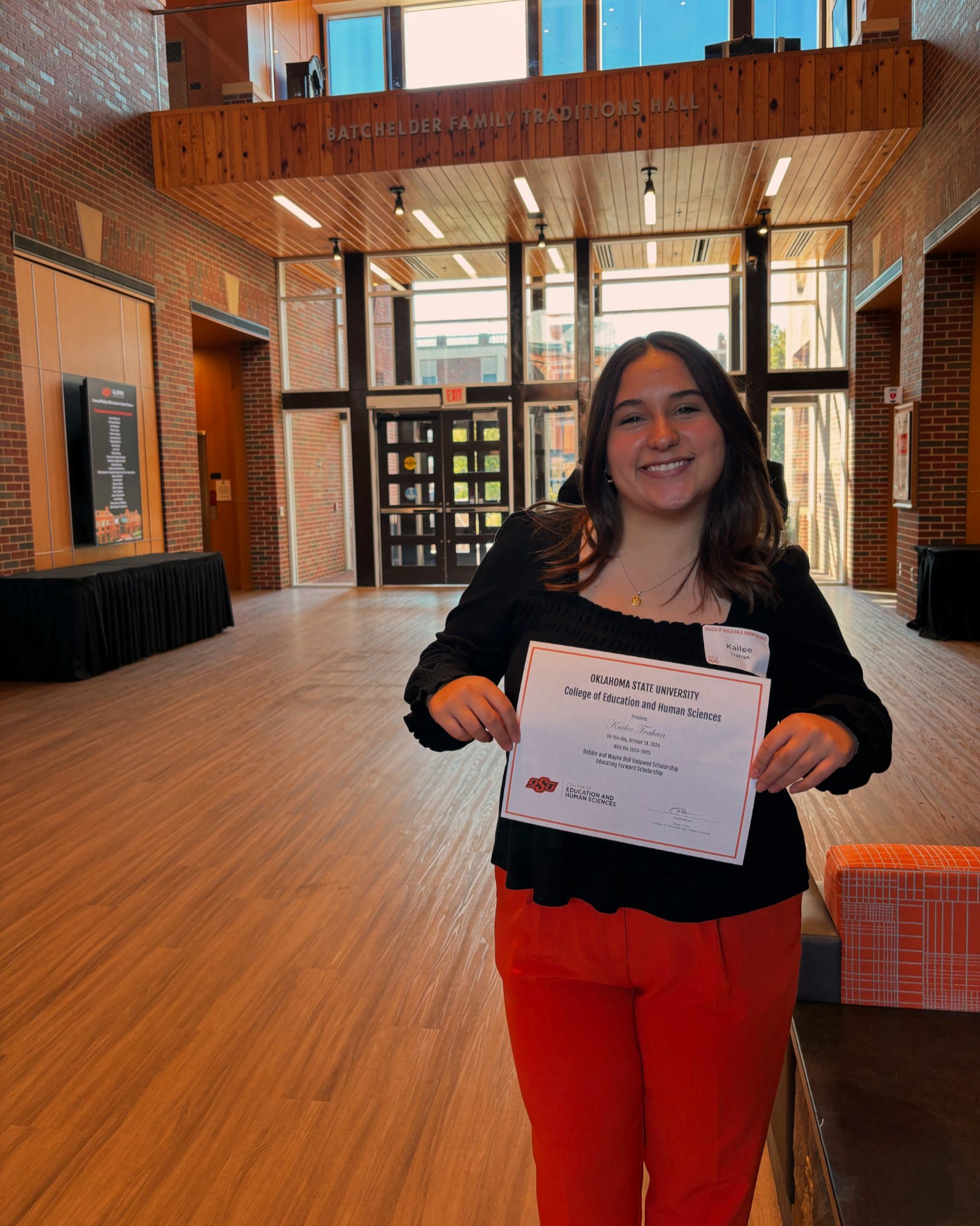 Member holding certificate for scholarship award