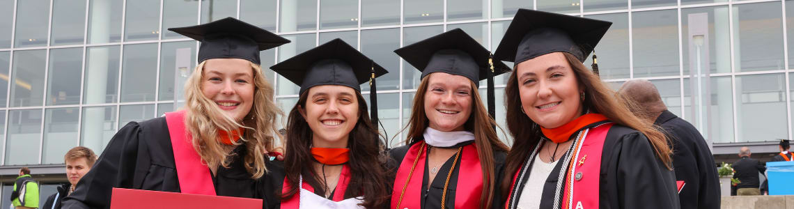 A group of students in front of an RPI200 backdrop with red and white balloons