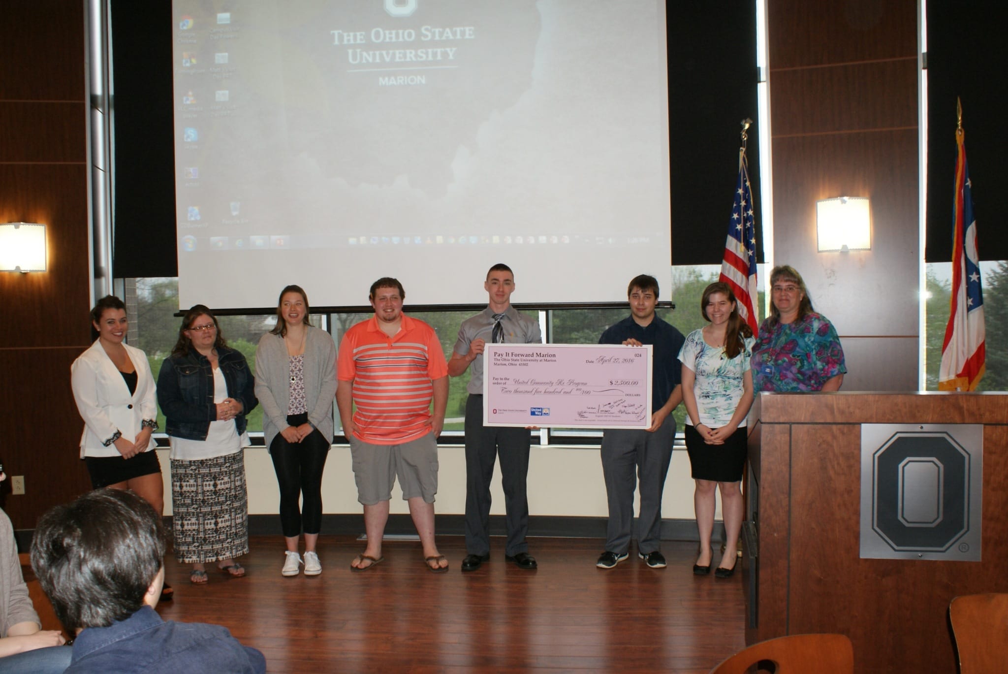 Students accepting check for United Community