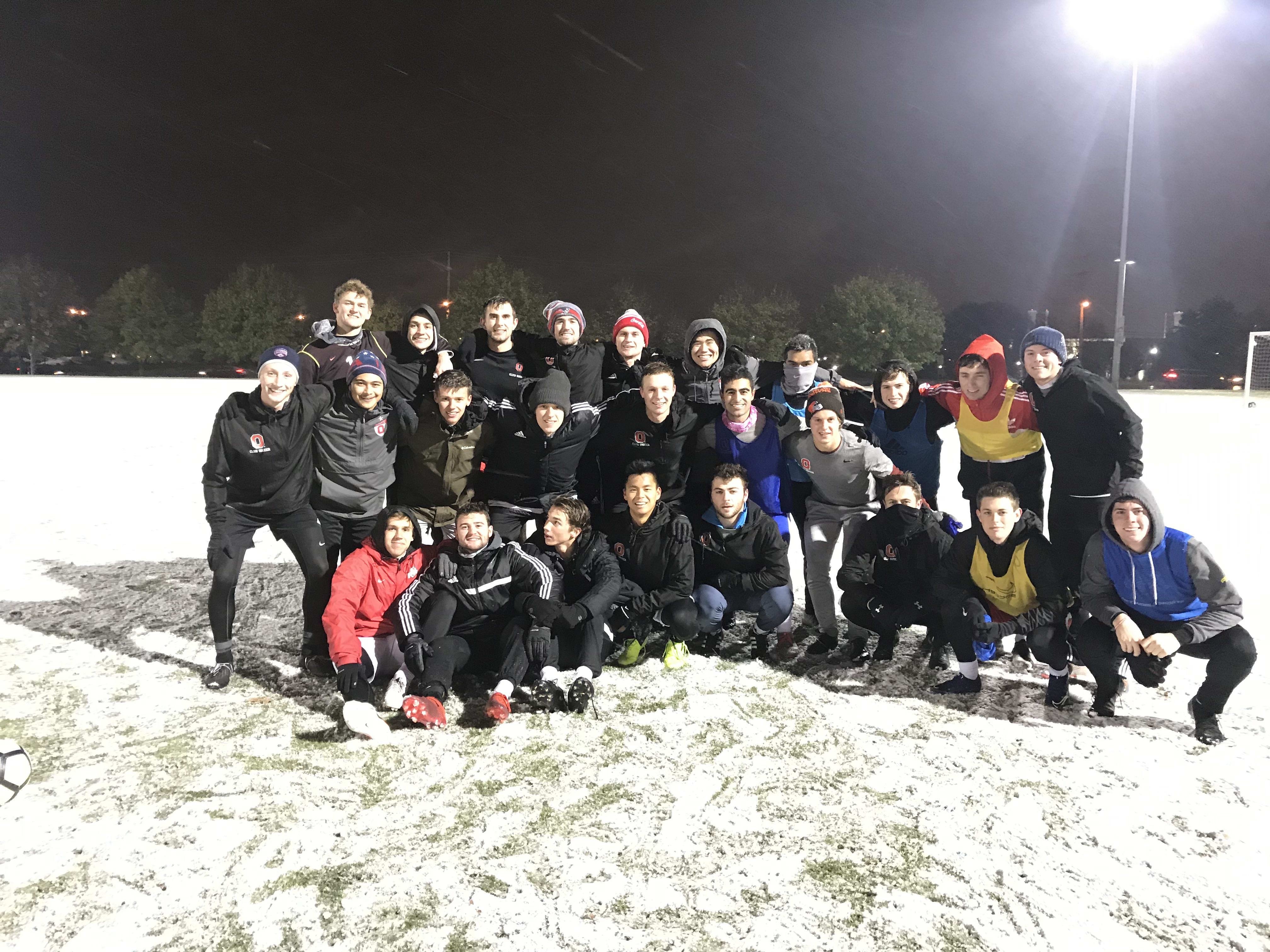 The Club Team on a snowy field, posing for a photo