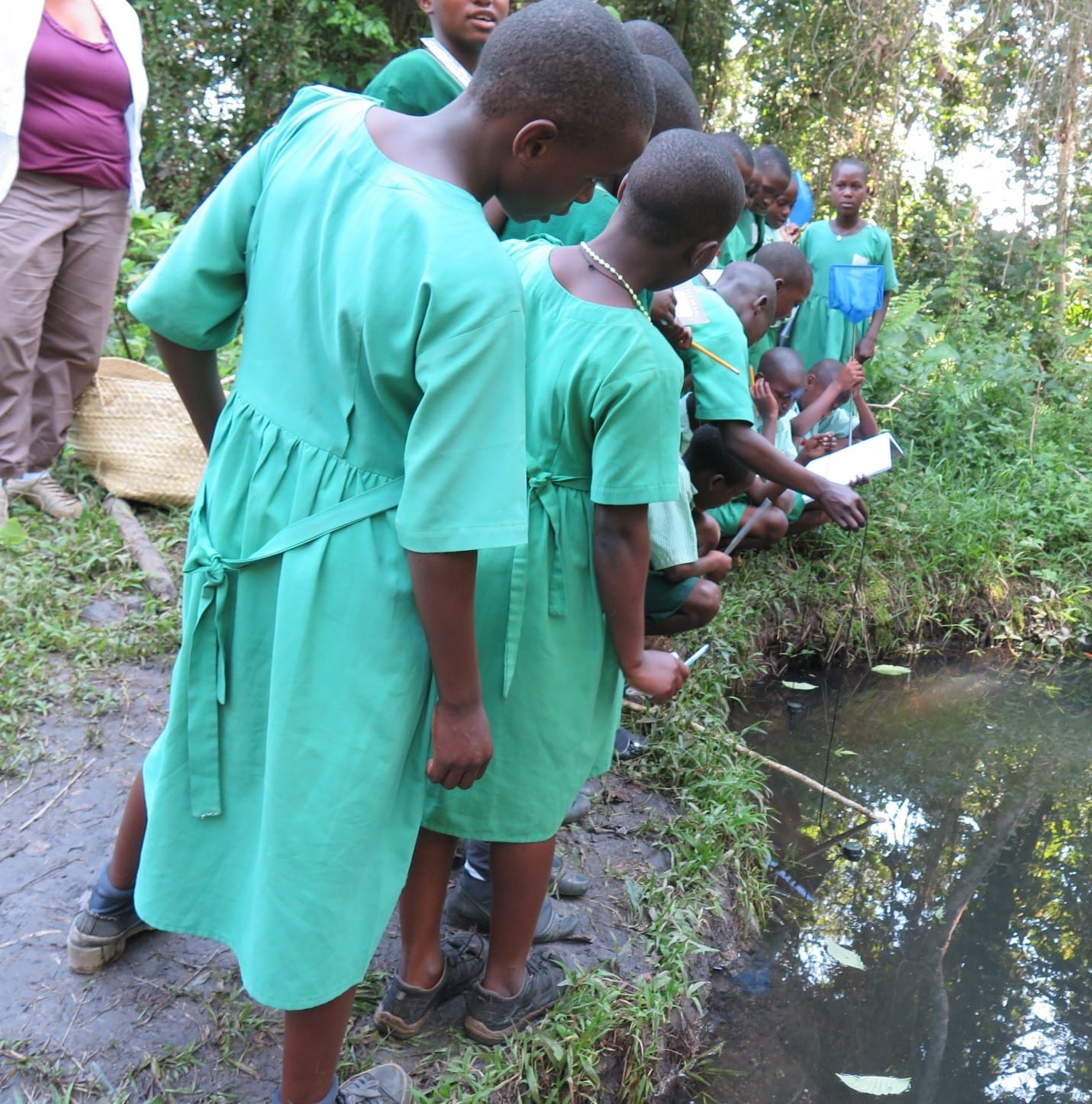 Students in Uganda examining water collection
