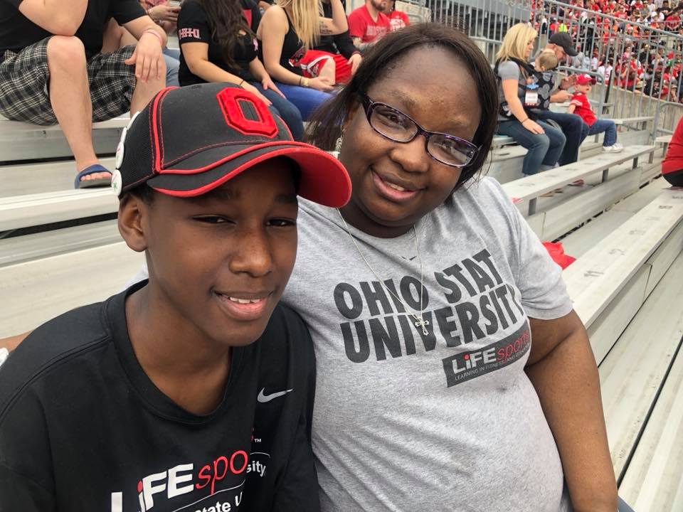 A child and adult sitting in OSU's stadium