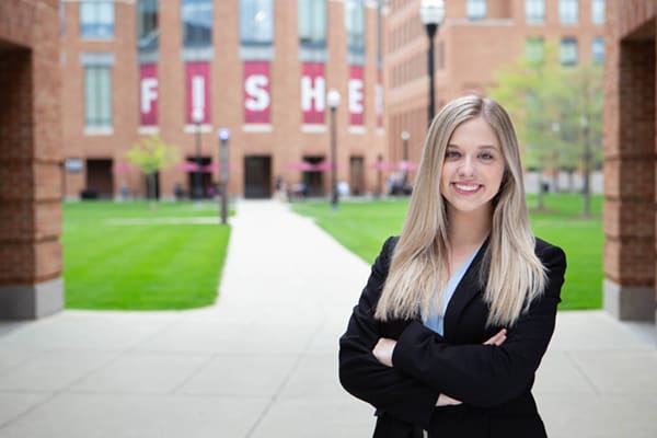 A girl in black blazer standing in front of Fisher