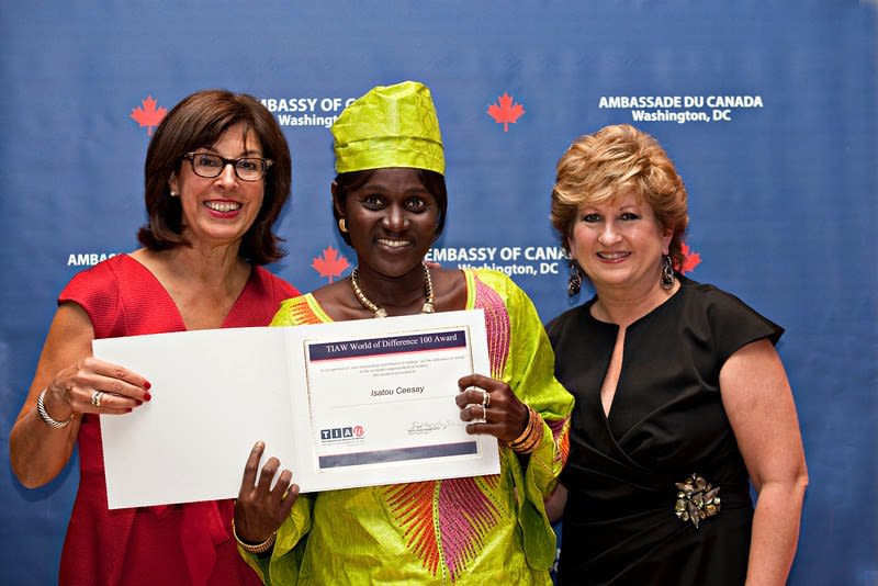 Three individuals standing with an award