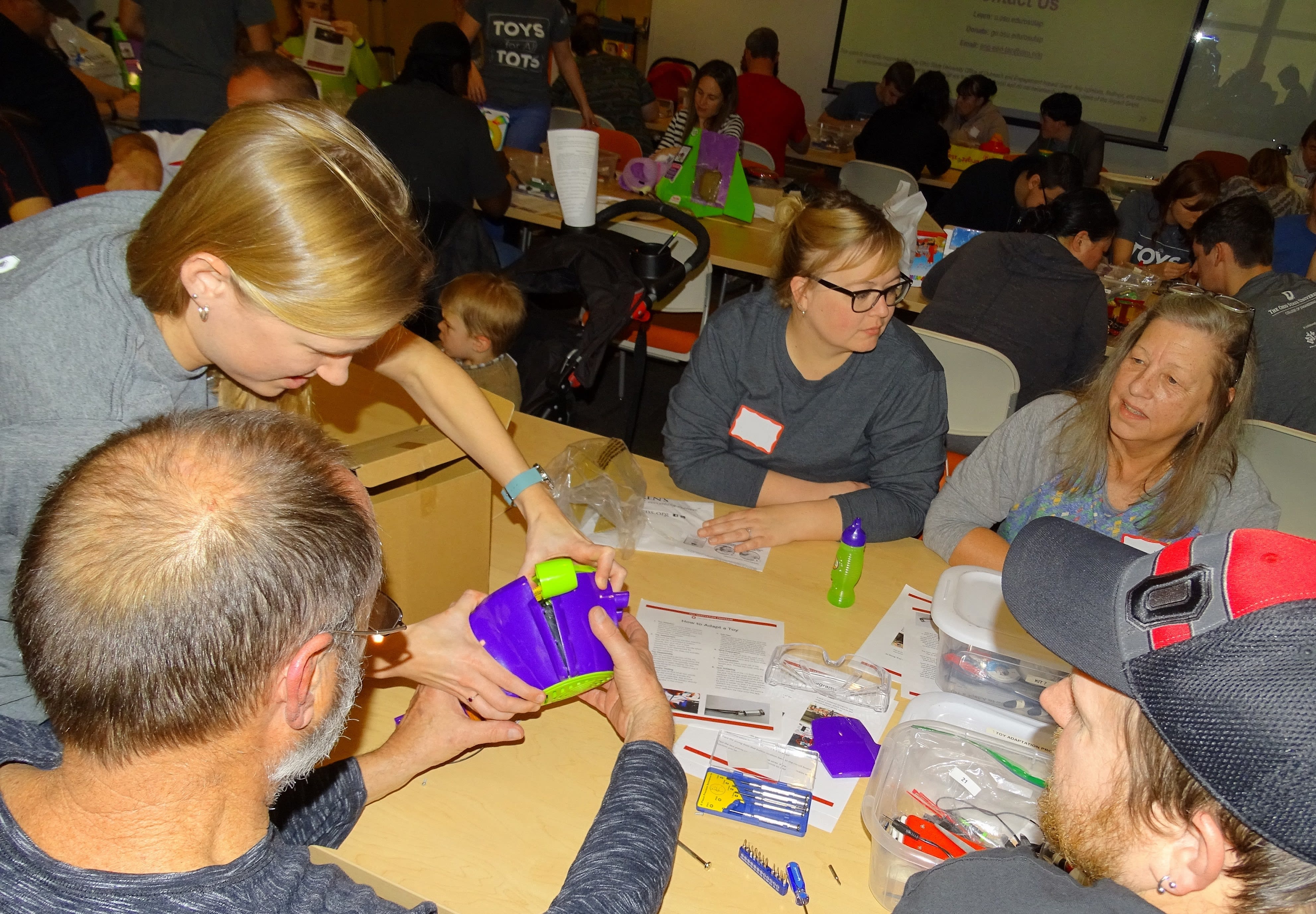 A room full of volunteers aiding with toys