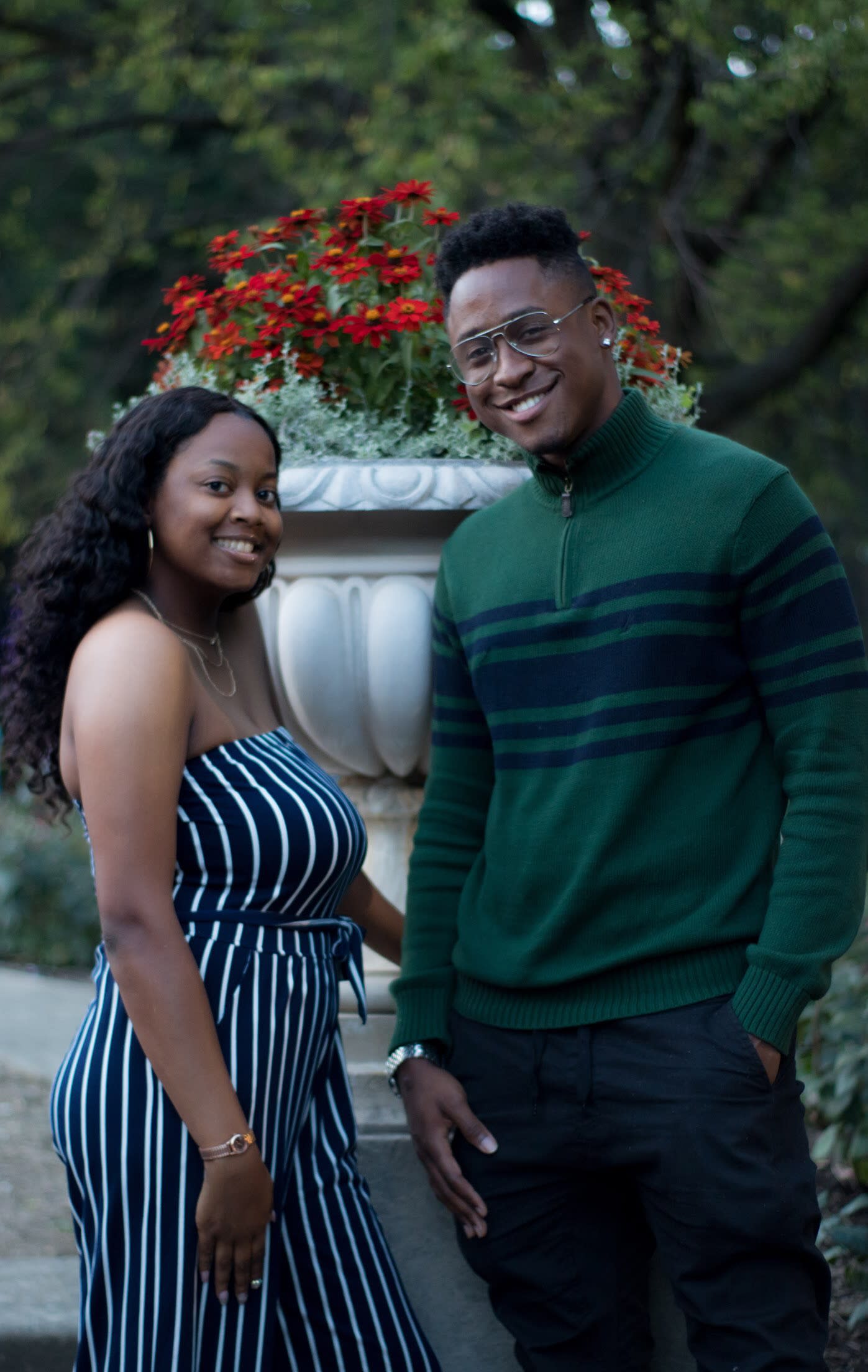 Two individuals with their shoulders to flowers