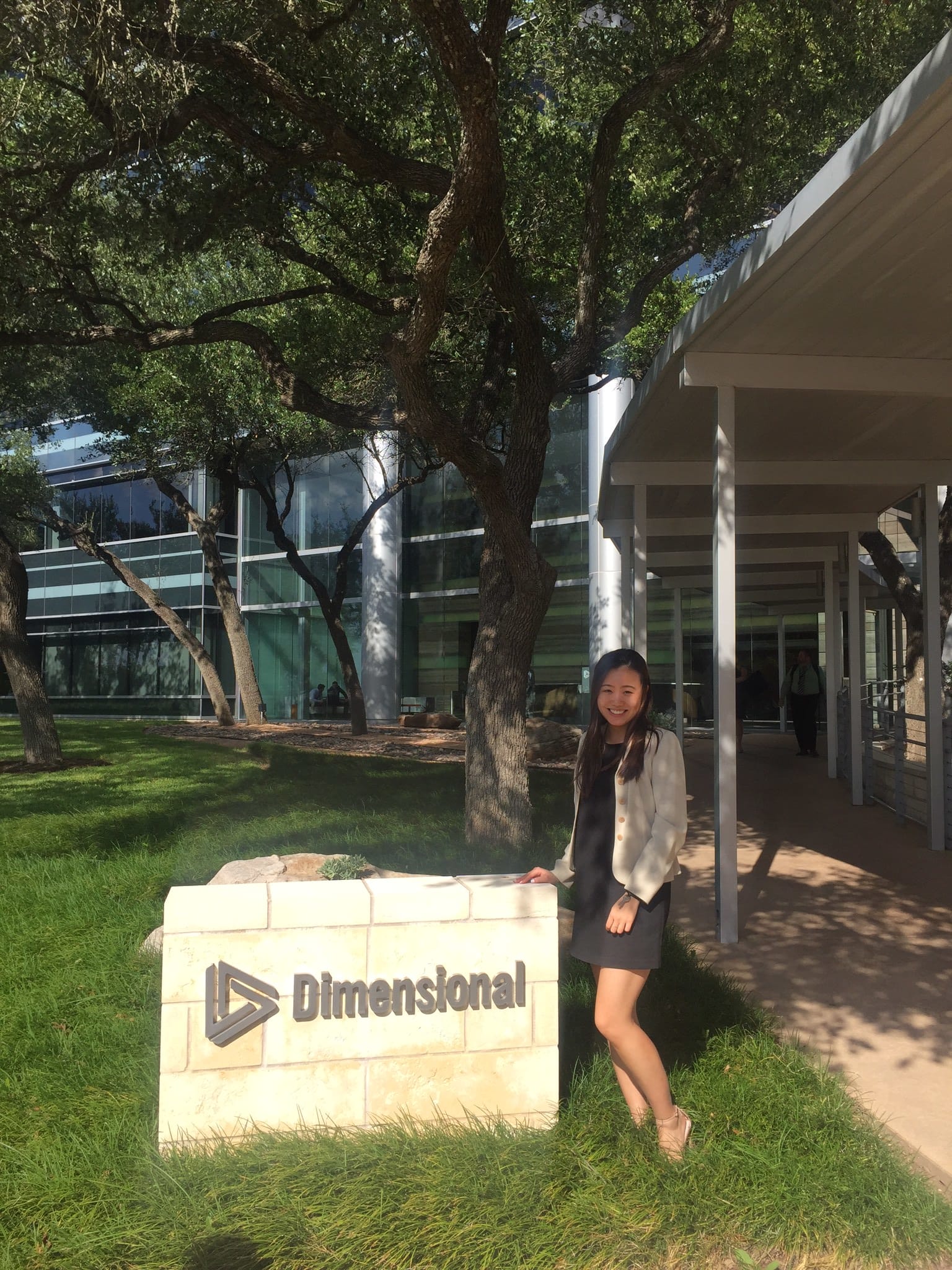 Lily Yan standing beside Dimensional logo stone