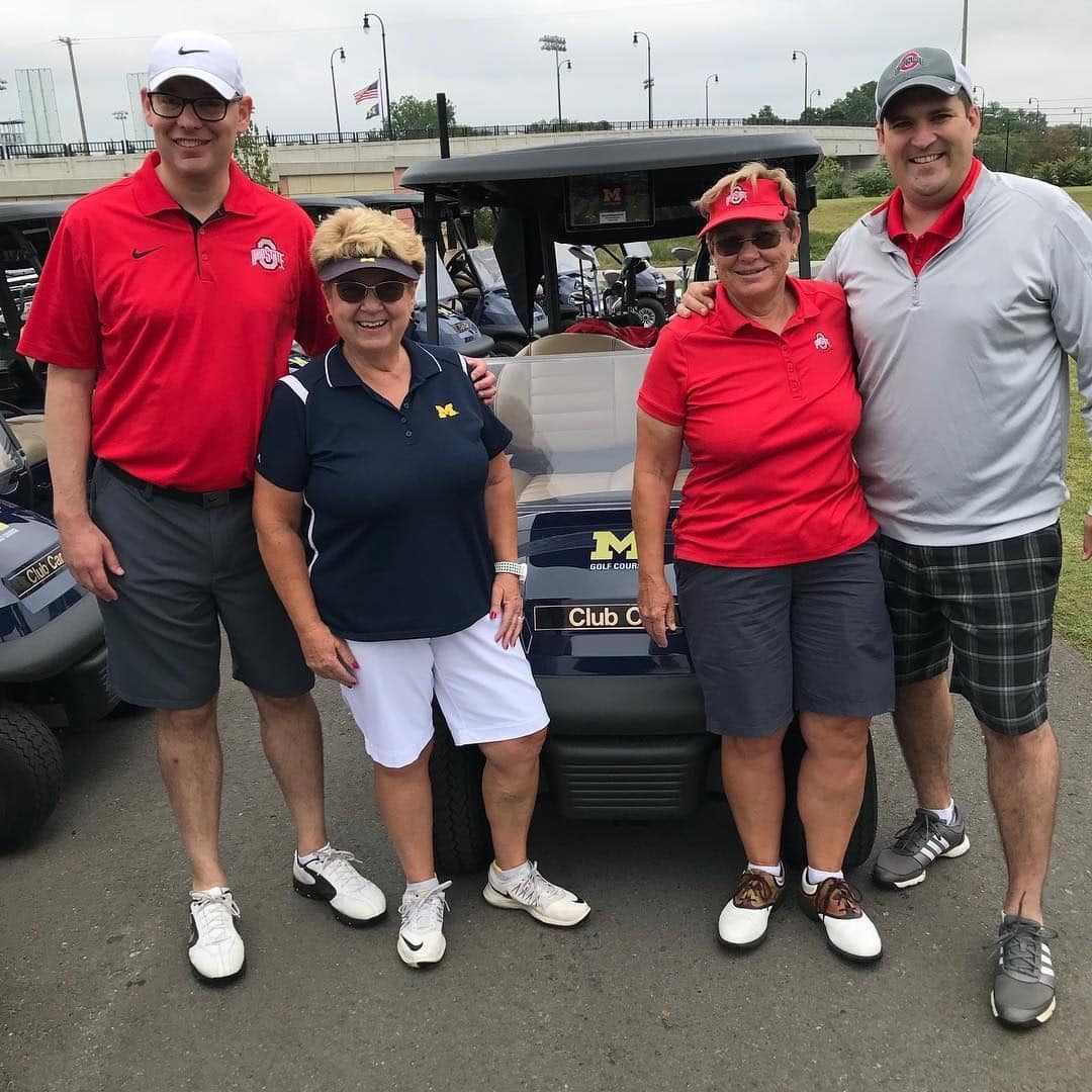 Deb Ballam and three others standing by golf cart