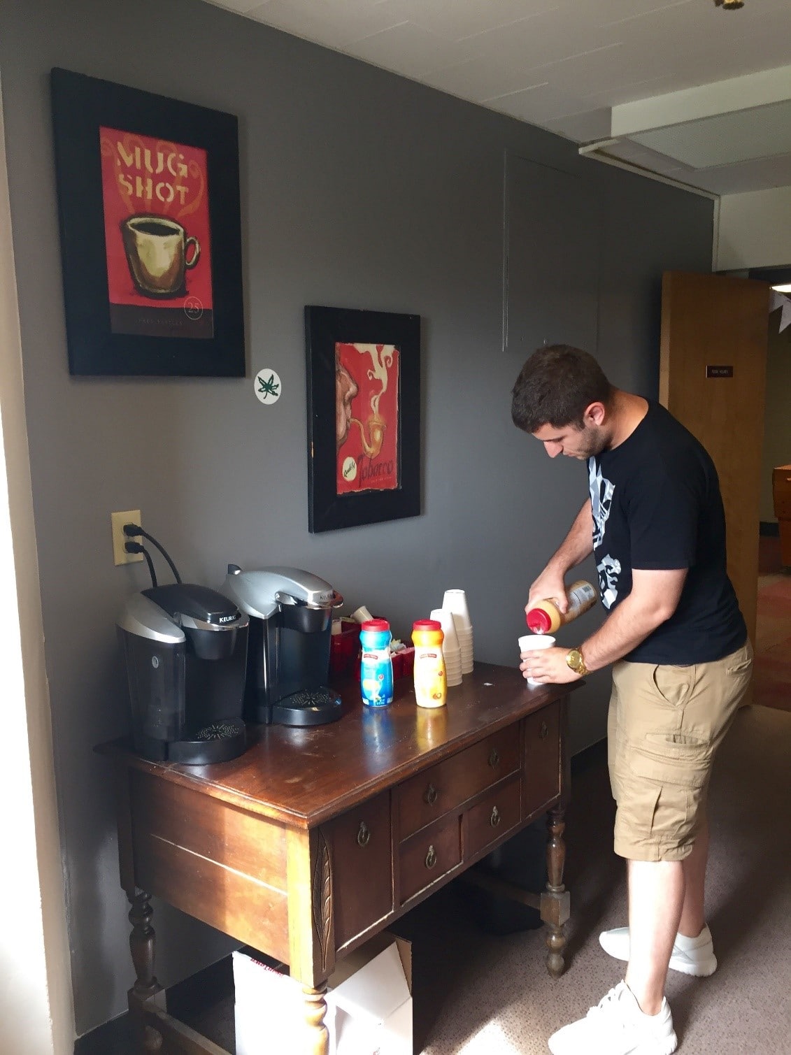 Student makes his coffee at communal coffee area