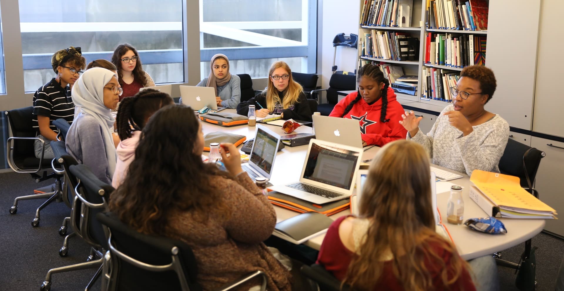 10 girls and their mentor in a meeting