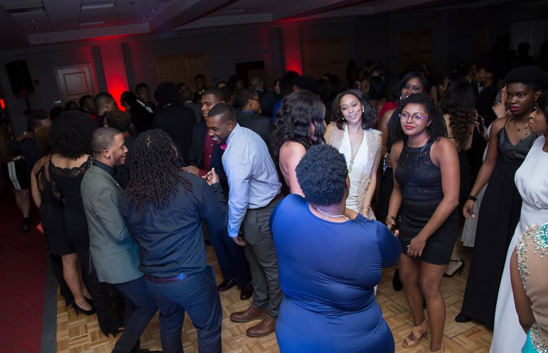 A large group of people dancing on a dancefloor
