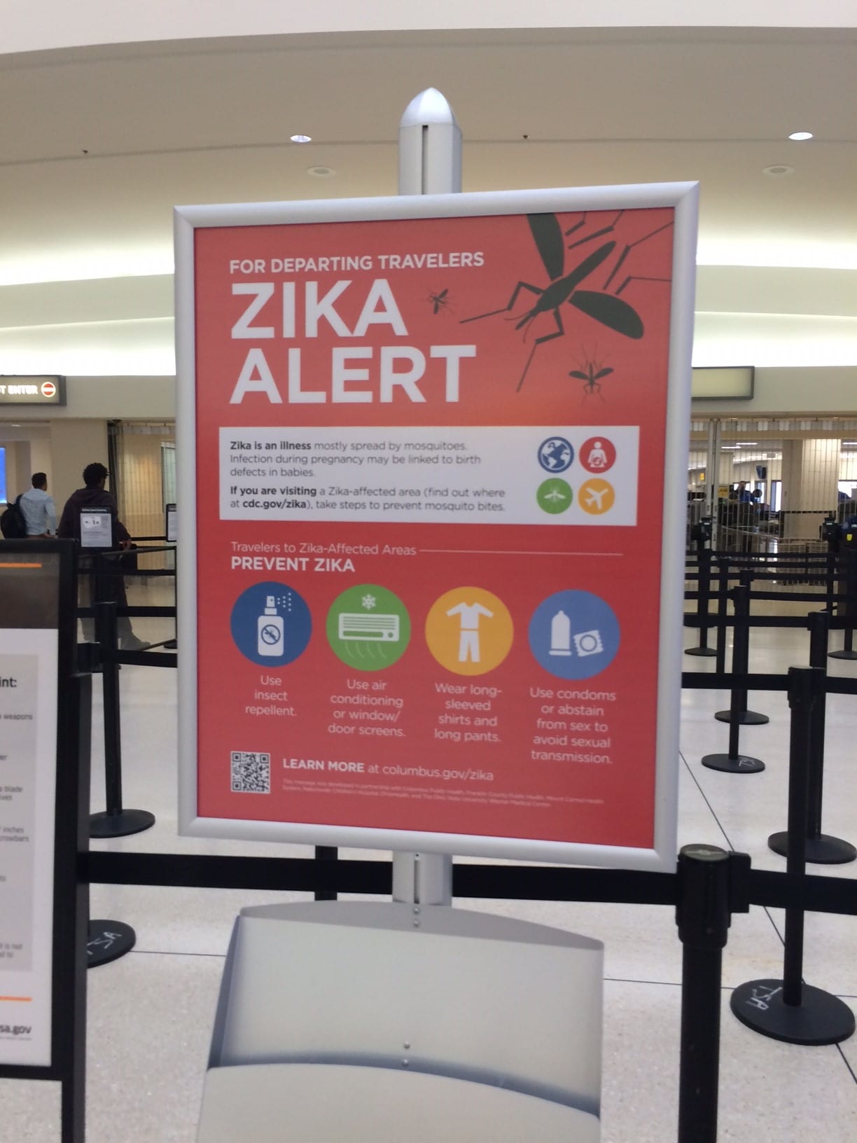 A Zika alert posted at an airport's security