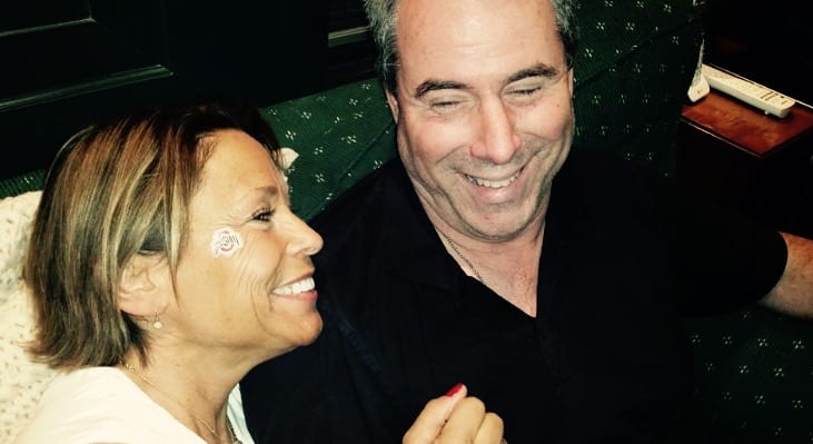 Jim and Janet smiling while on a green couch