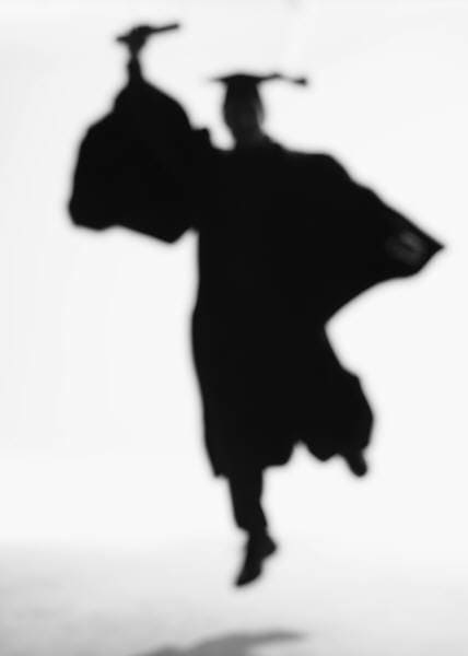 Blurry picture of a graduate jumping with diploma