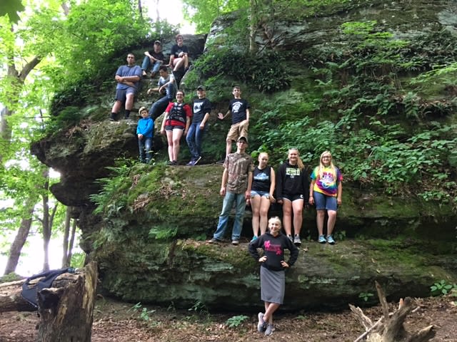 Campers scattered on a large rock formation