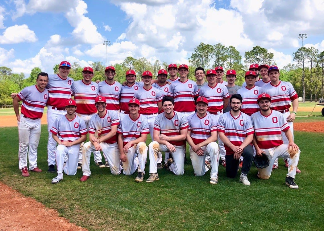 The Baseball Club on the baseball field, smiling