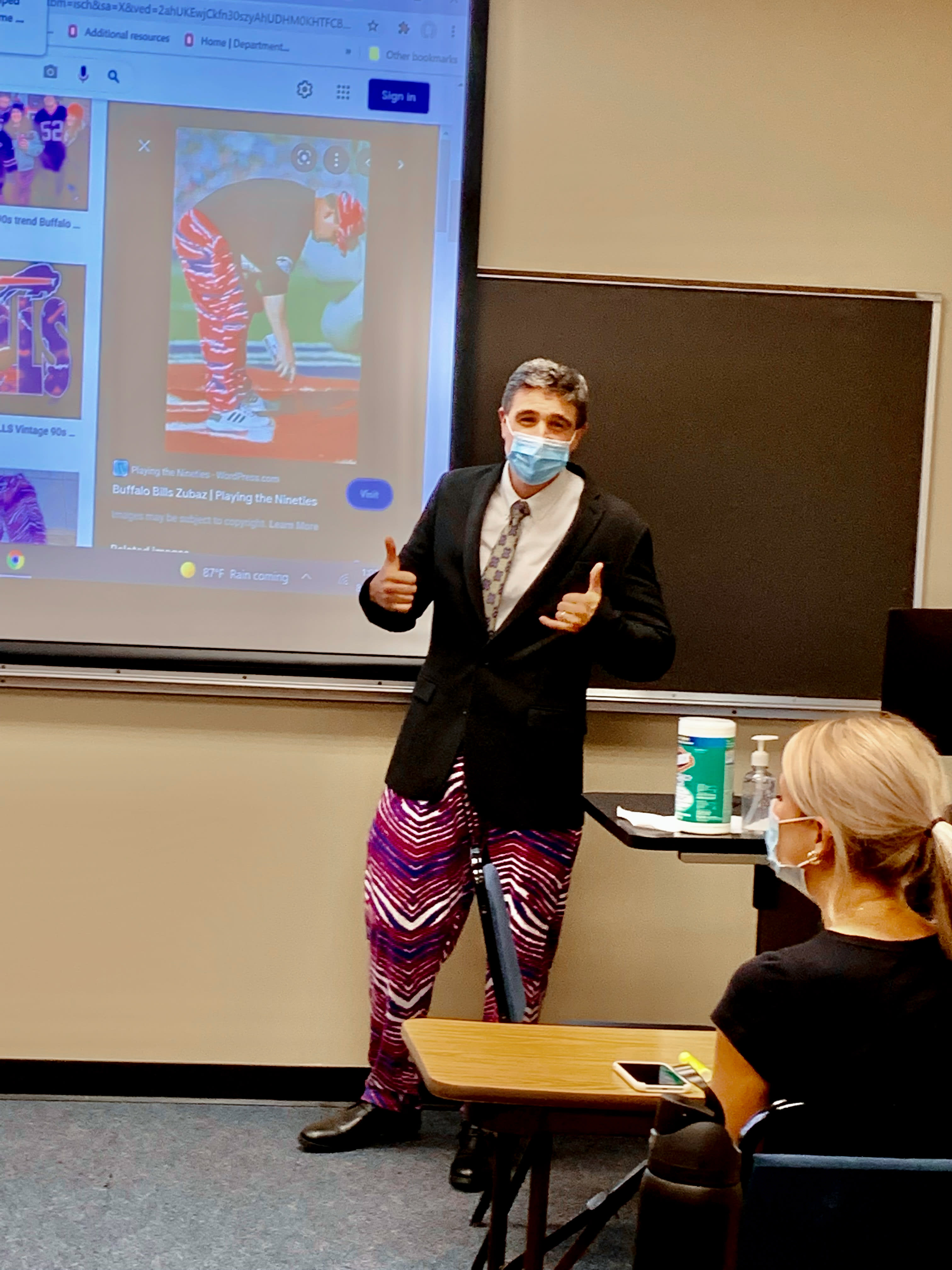 With crazy patterned pants, a man lectures a class