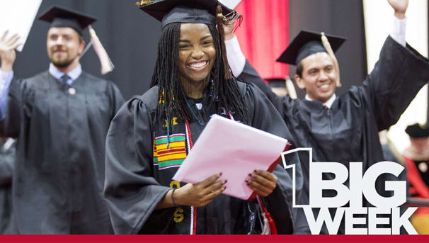 Three graduates receiving their diplomas