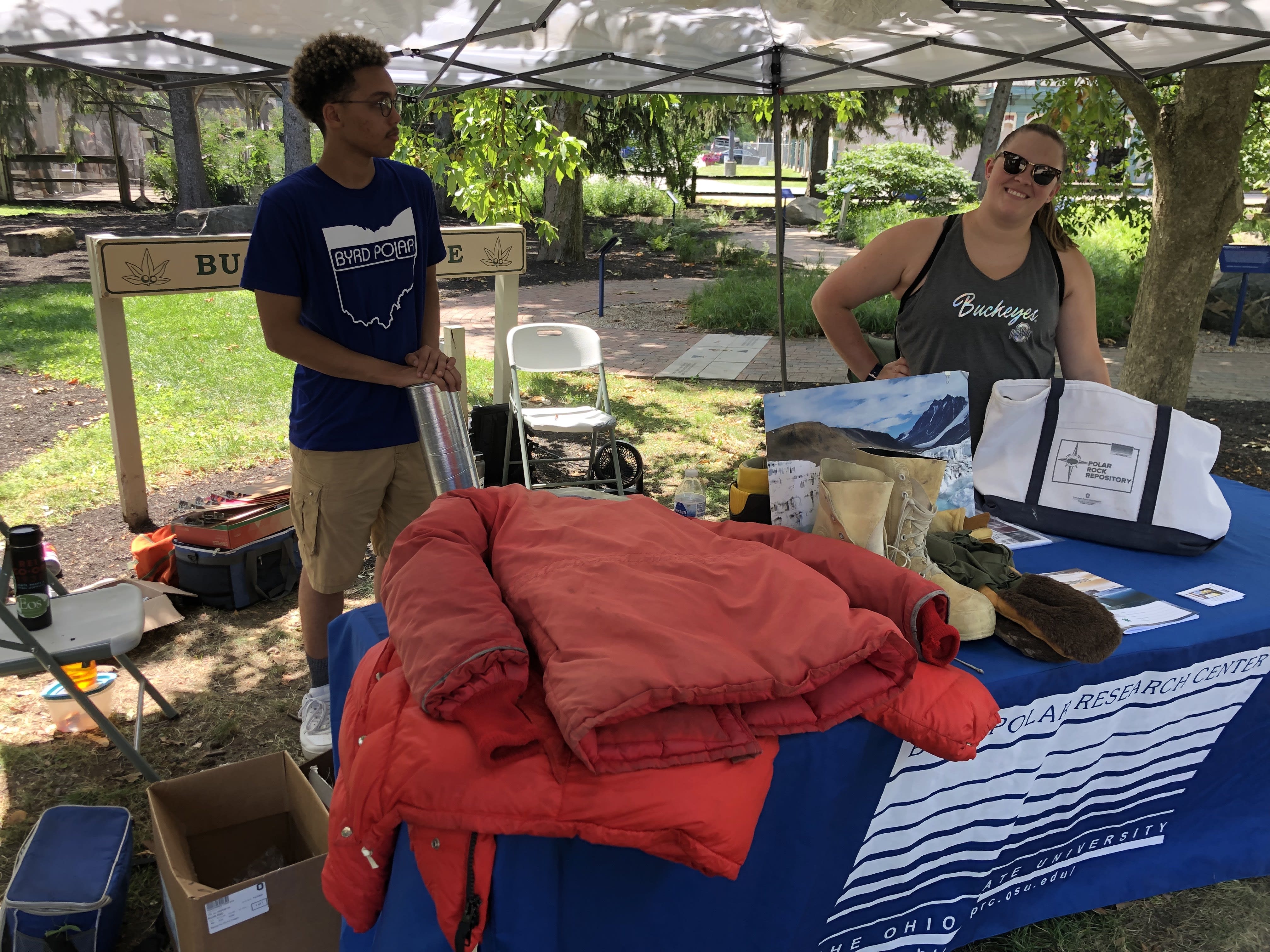 Two volunteers behind a booth