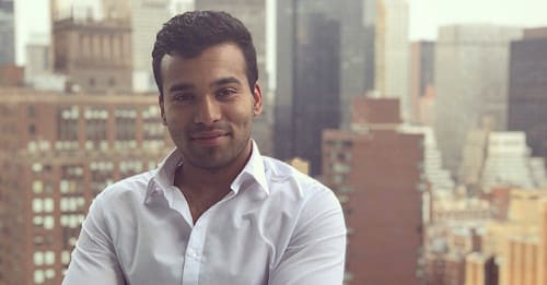 Ani's headshot with a city line behind him