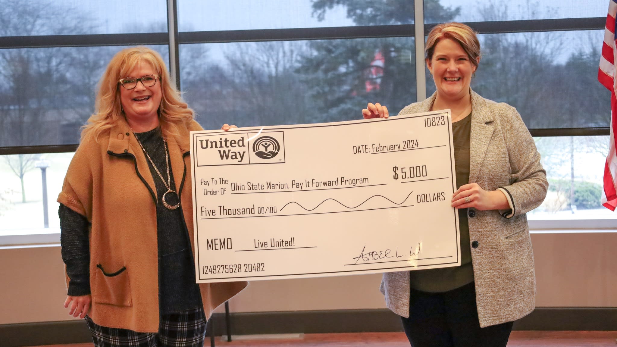 Two women on either side of the program check