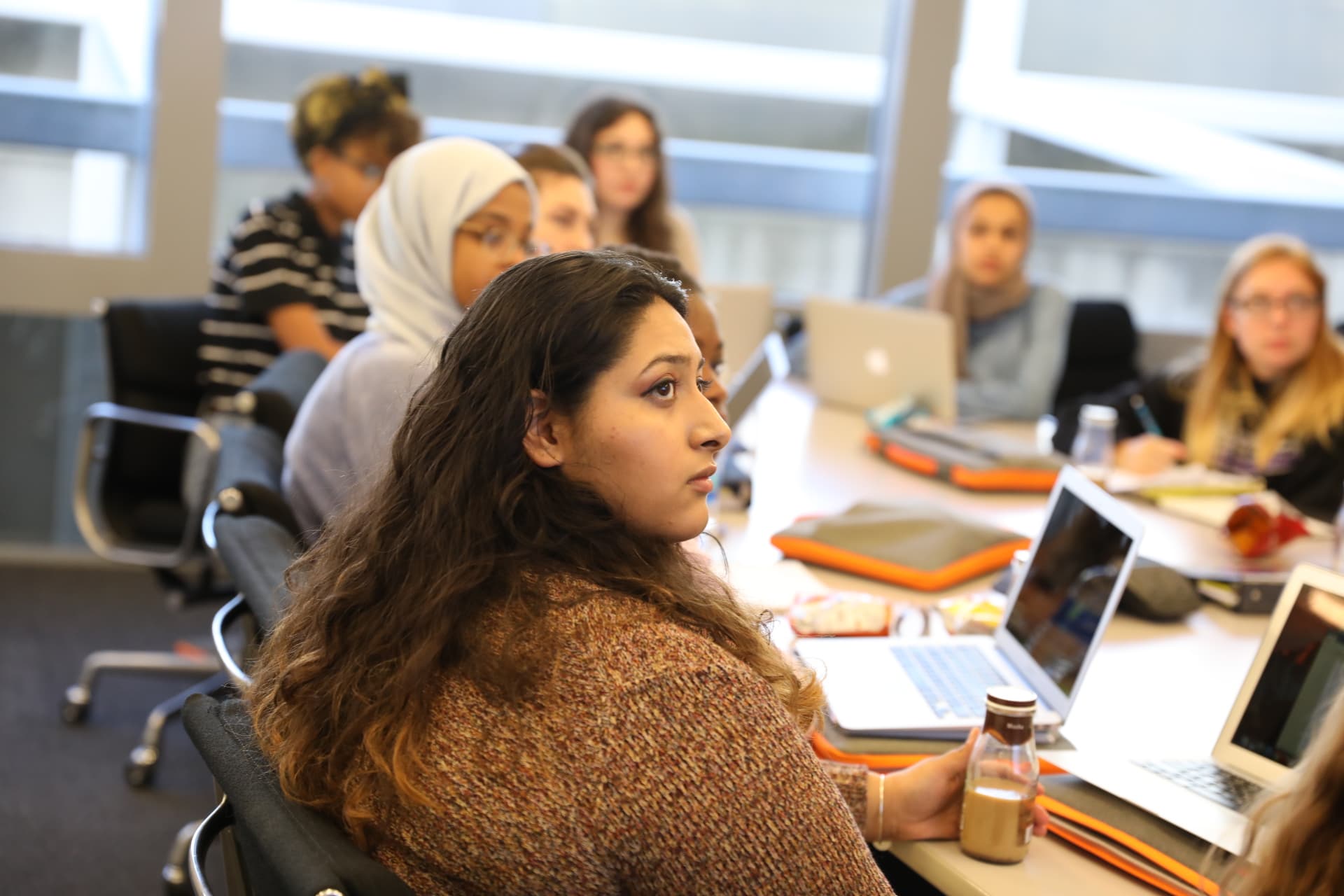A table lined with girls and their laptops