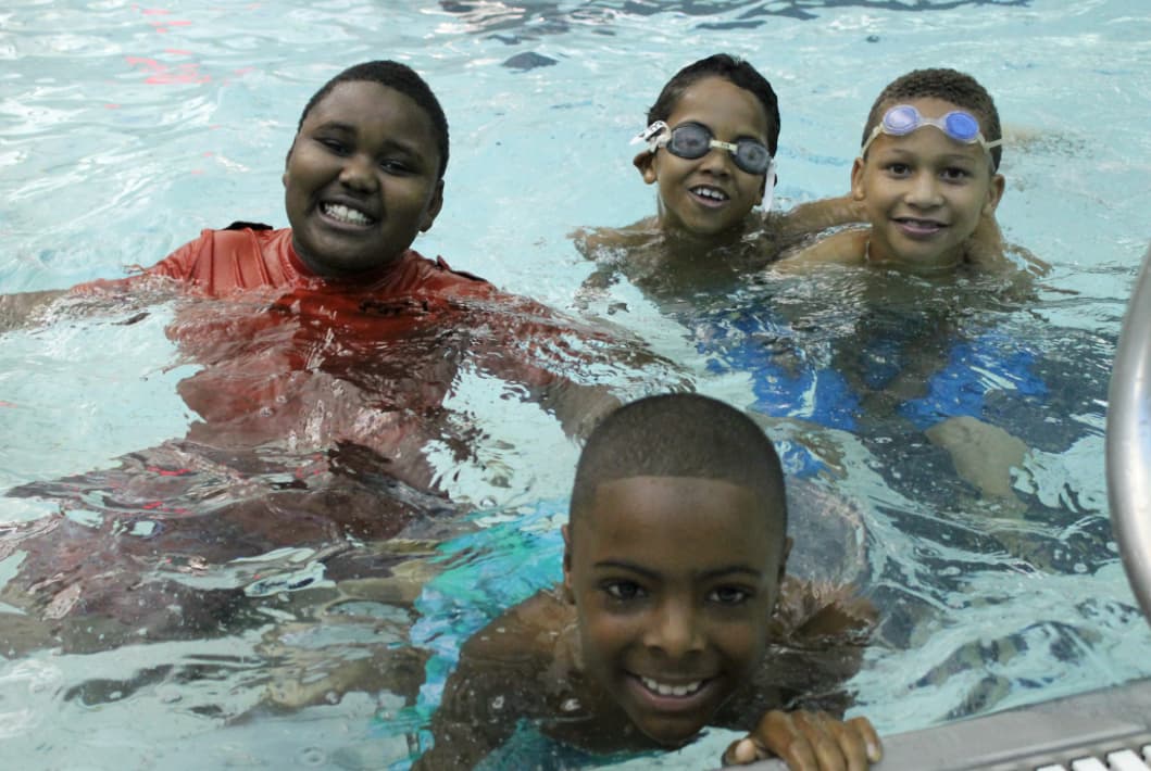 Four children in a swimming pool