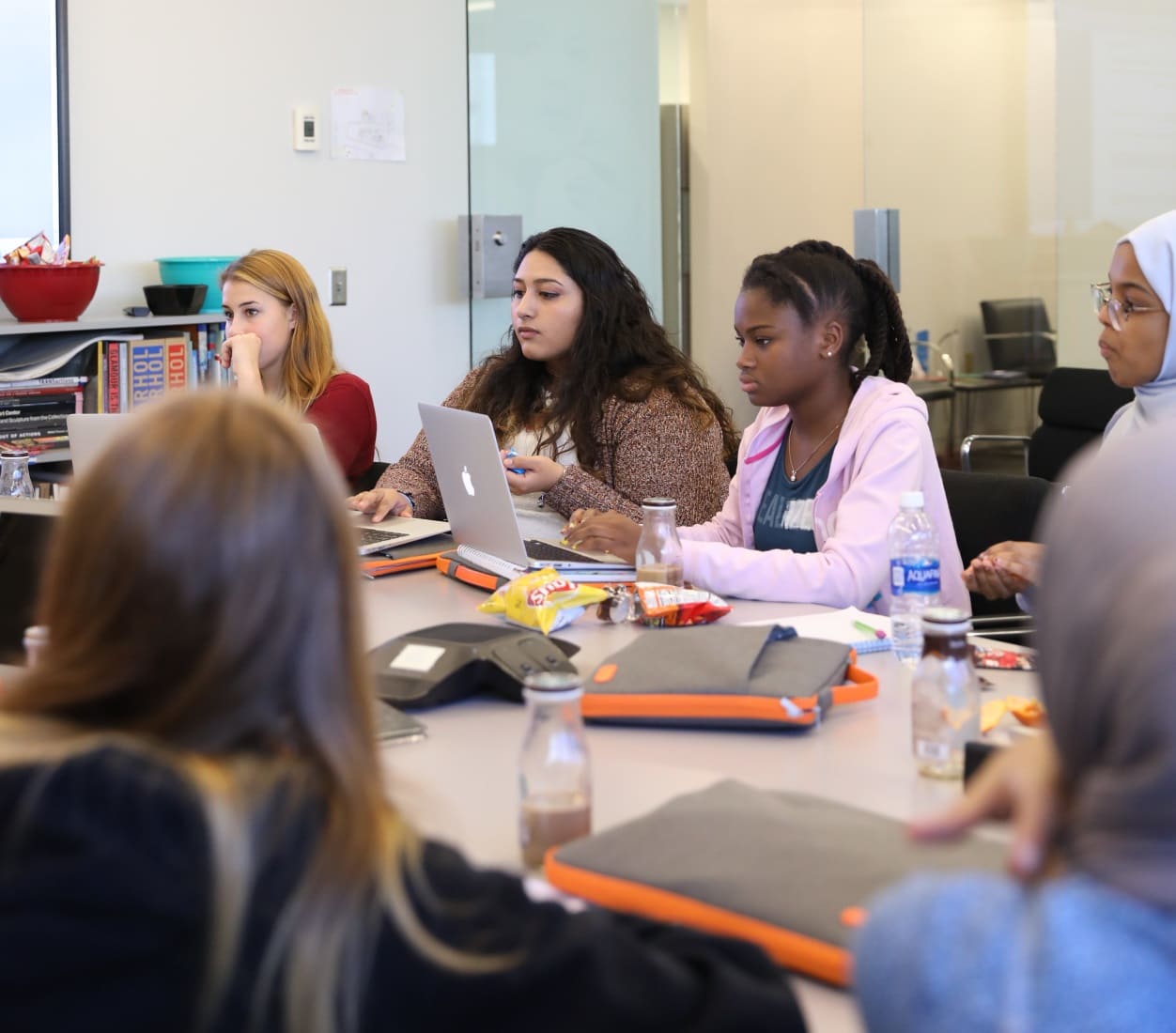 A large group of girls sitting at a long table