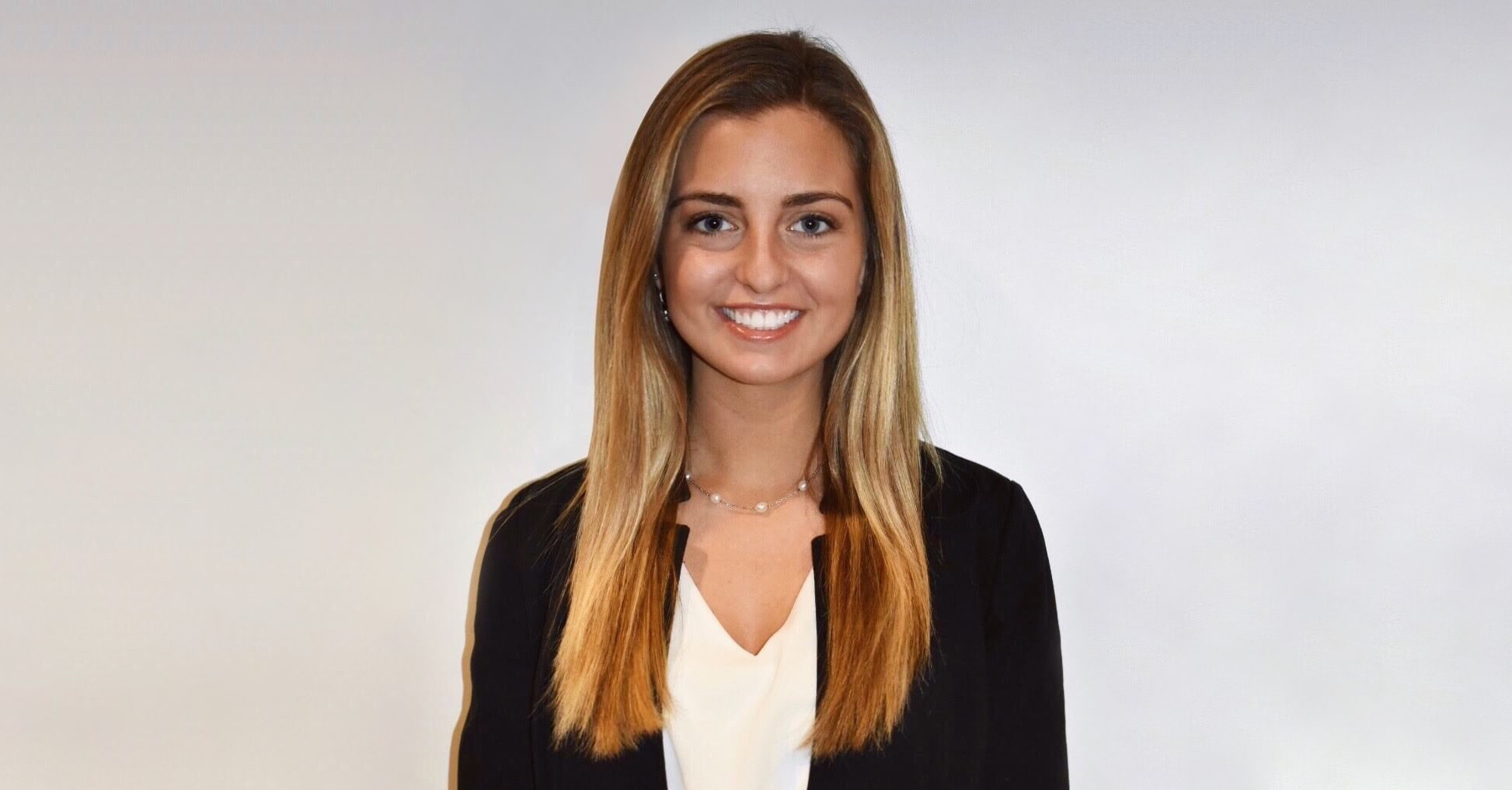 Ali's professional headshot against white wall