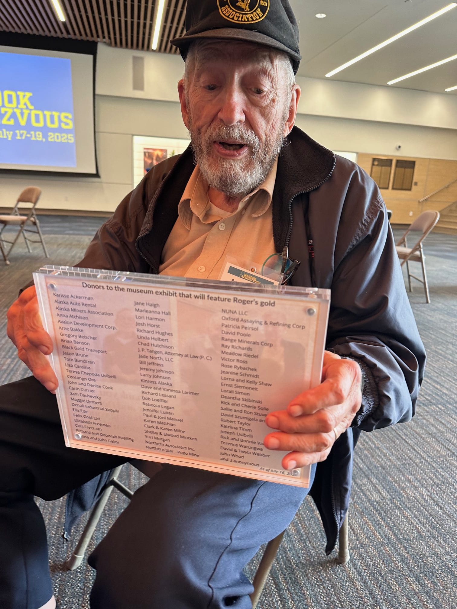 Roger examines a recognition plaque.