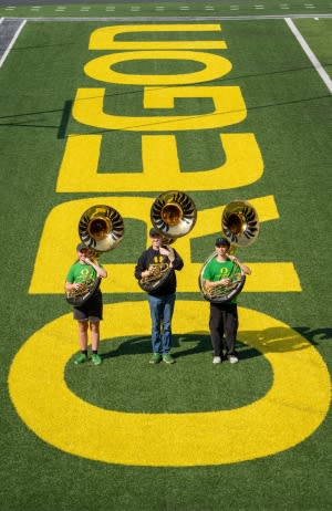 Three members of the sousaphone section in Autzen