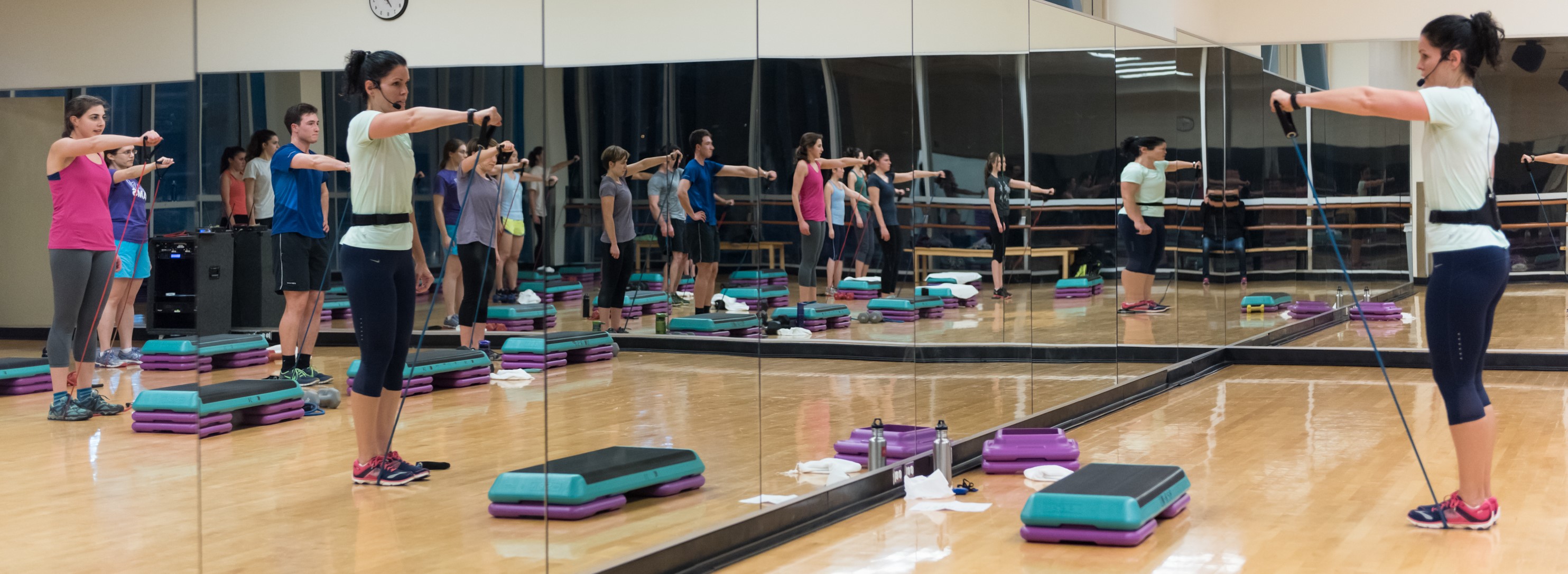 Instructor taking a group fitness class.