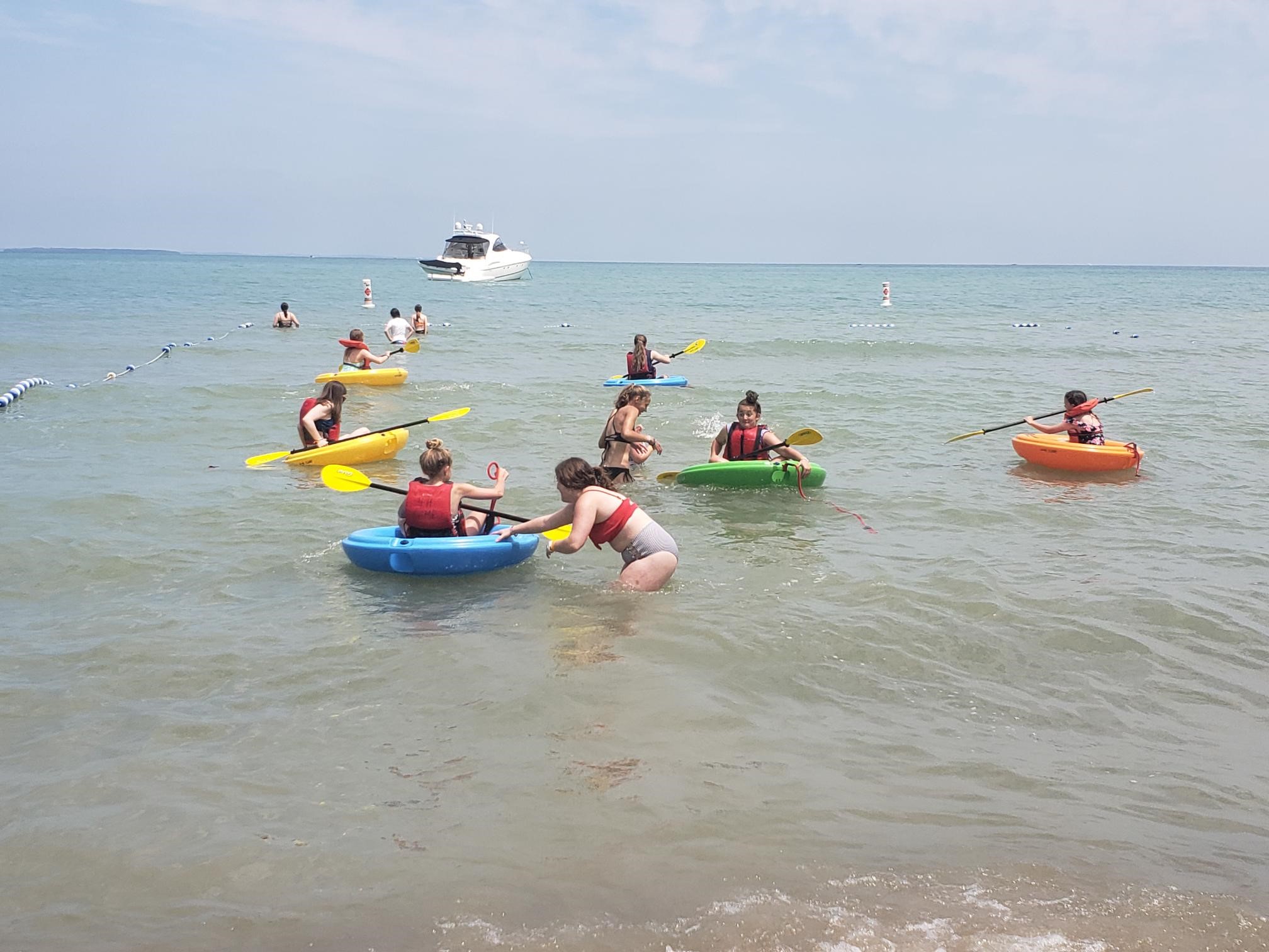 4-H campers corcling on a lake during 4-H camp.