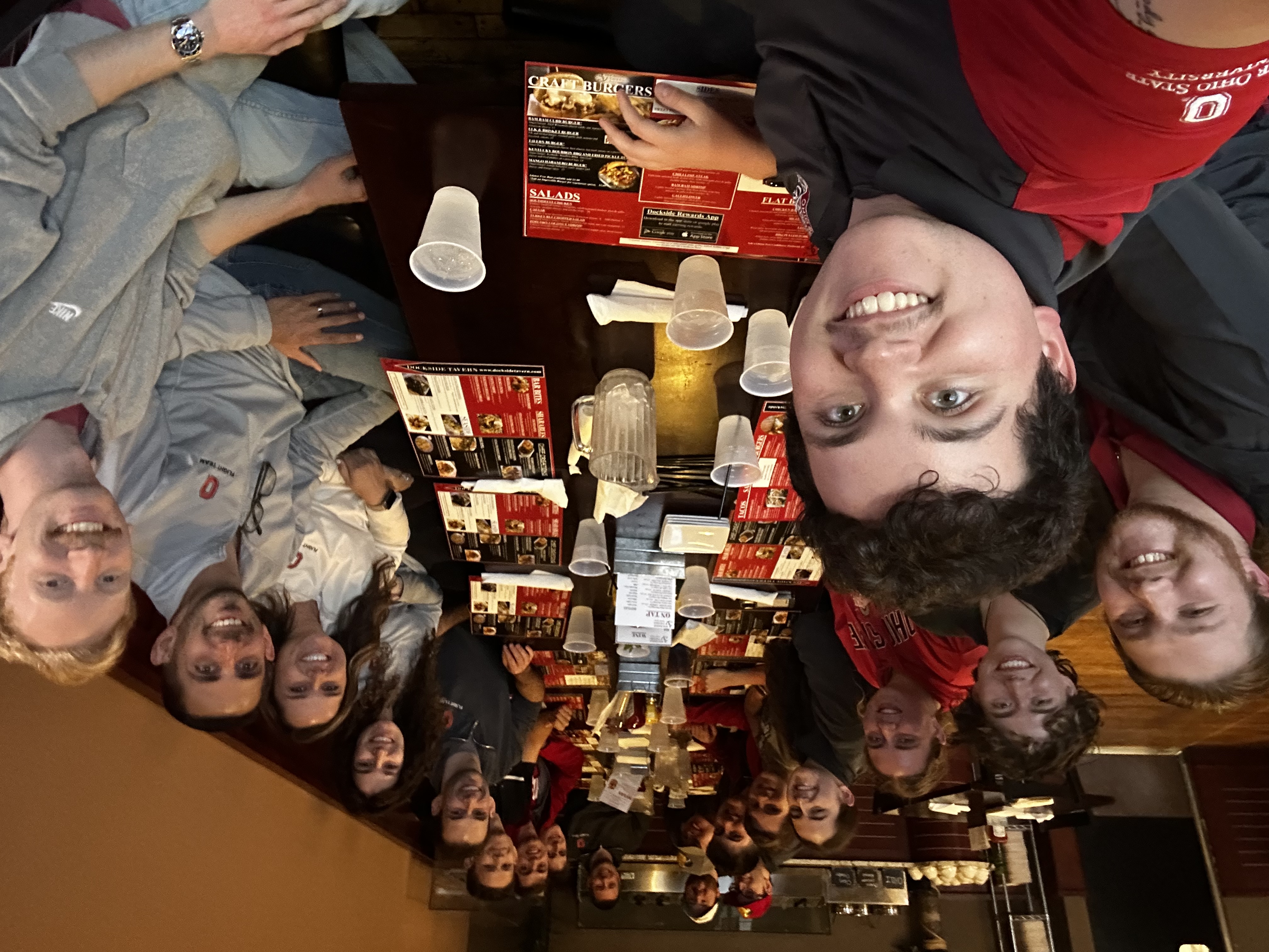 The Ohio State Flight Team sitting for a selfie at a restaurant table