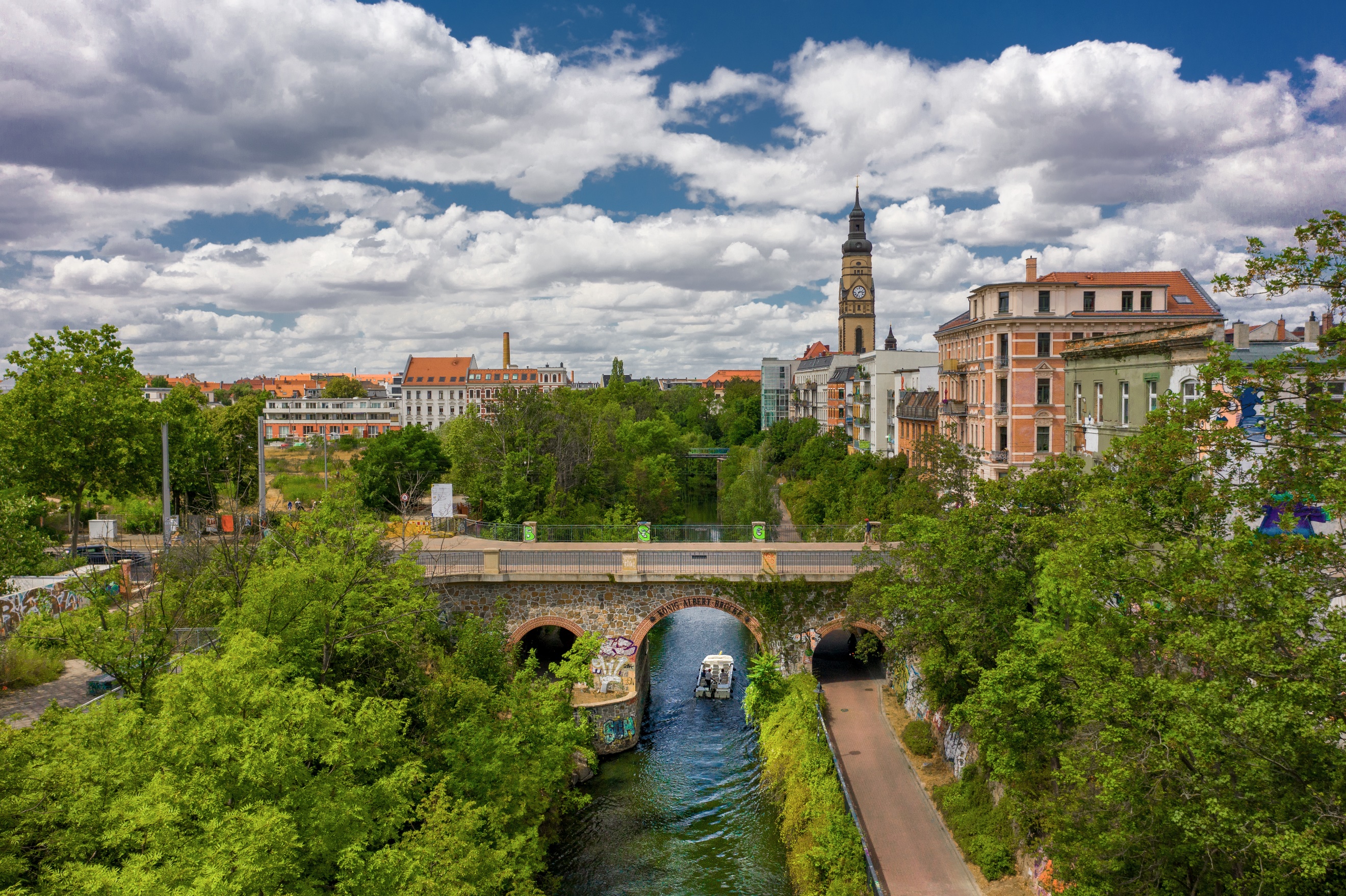 A bridge over a river surrounded by trees

Description automatically generated