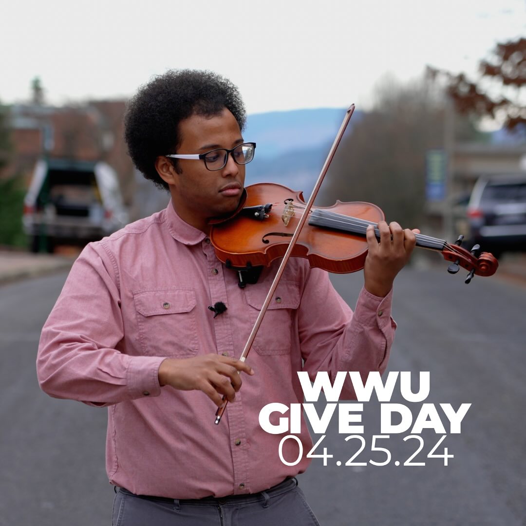 a person plays the violin in the middle of a quiet street