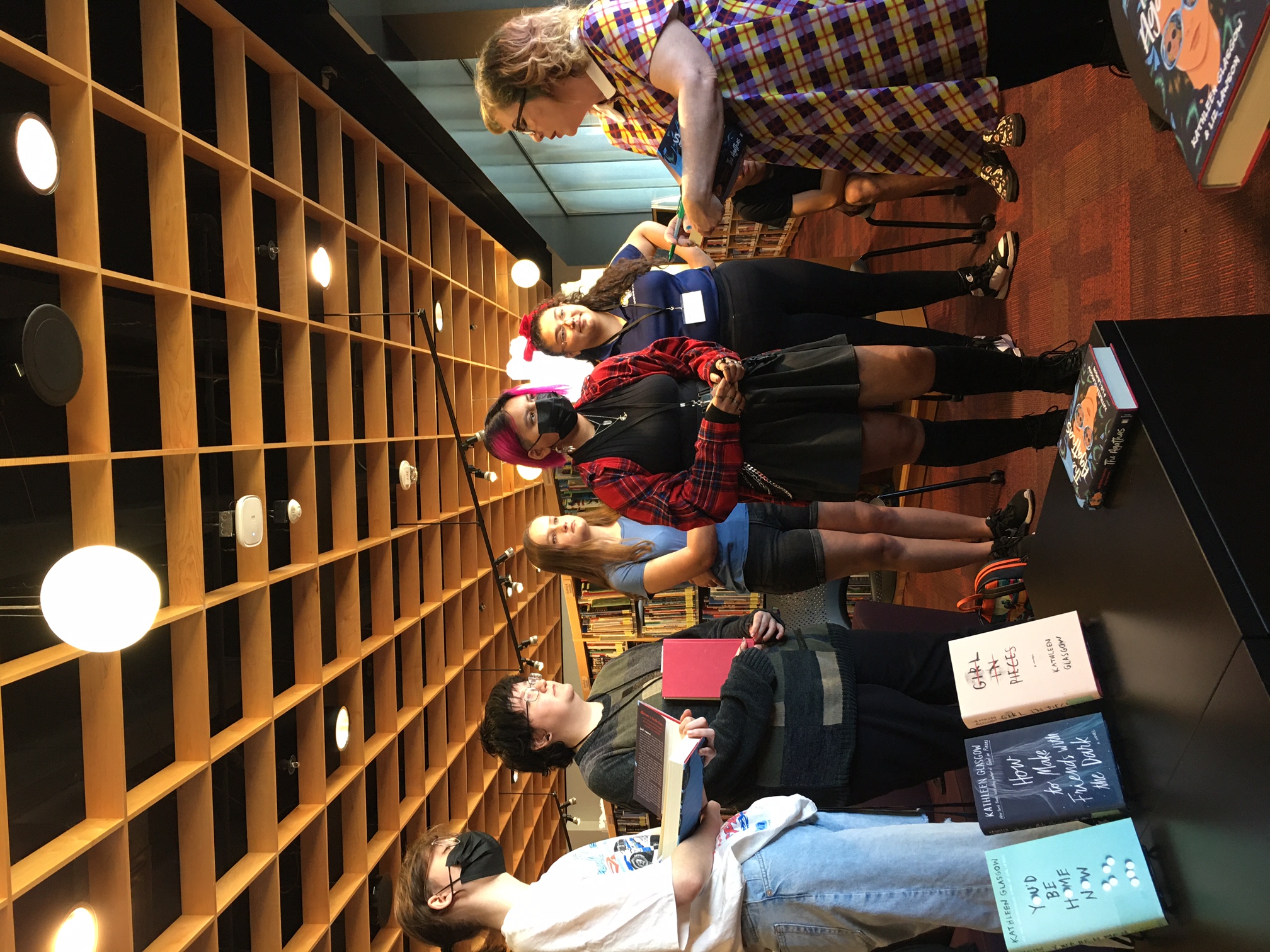 Reading Ambassadors talk to Kathleen Glasgow as they wait for their books to be signed.