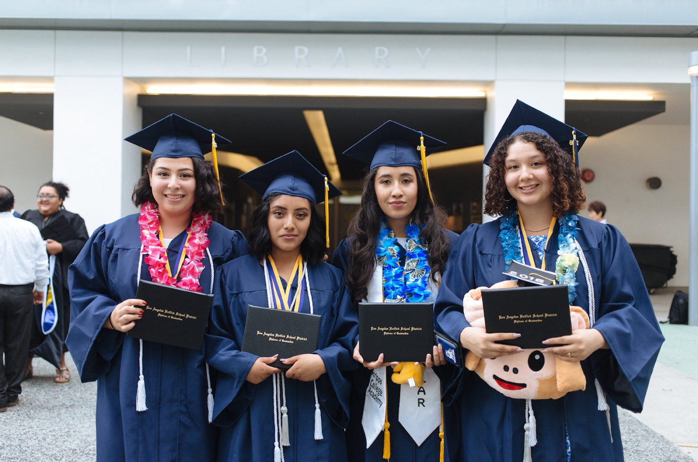 A group of women wearing graduation caps and gowns

Description automatically generated