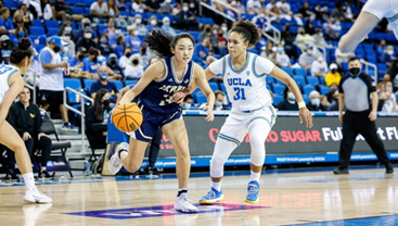 Image from Women's Basketball Foreign Tour – Guadeloupe 2023 campaign page featuring a UC Irvine player dribbling past a UCLA defender.