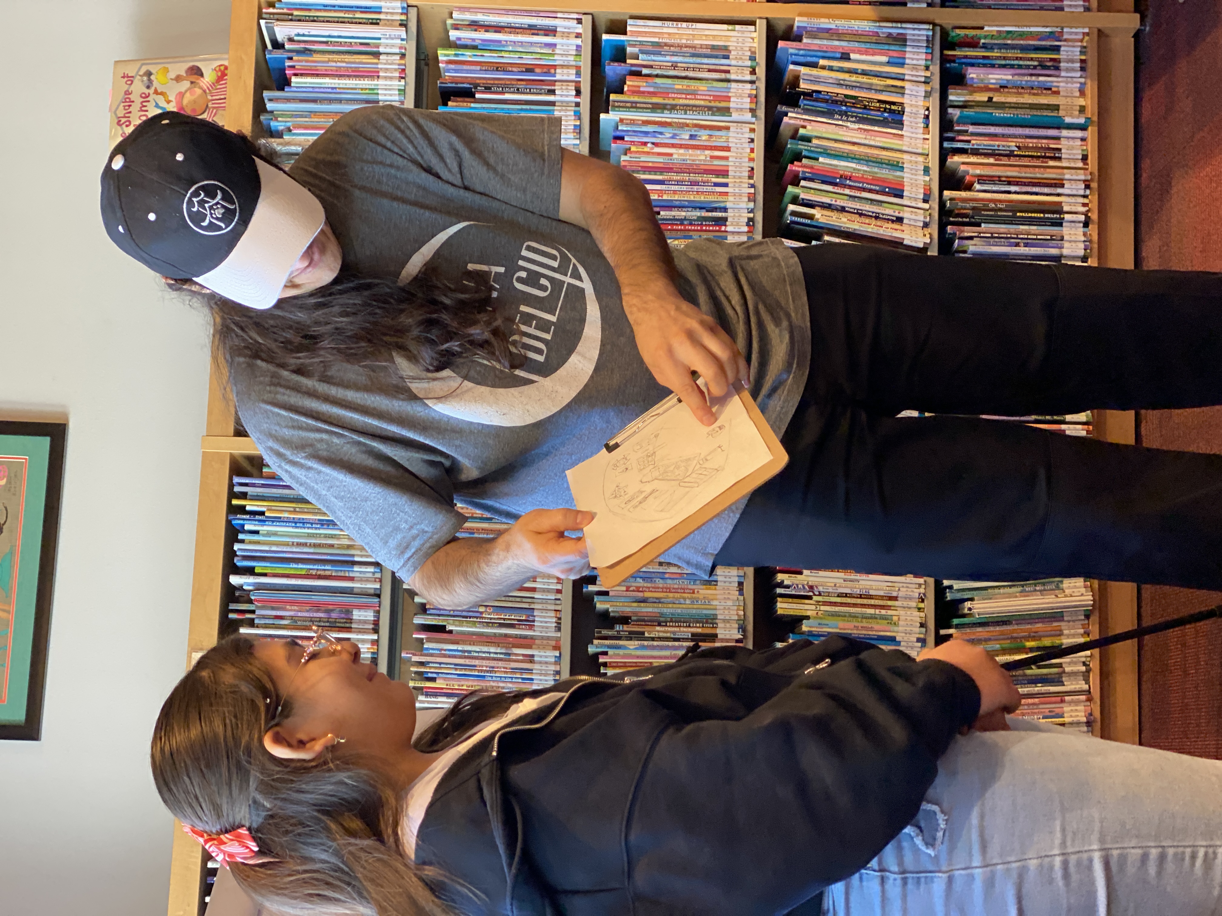 middle schooler shares her art with author and illustrator Jose Pimienta